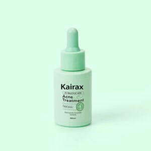 A 30ml bottle of Kairax Acne Treatment Facial Serum with a mint green dropper cap, featuring a label that reads "2% Salicylic Acid + Niacinamide Ceramide" on a light green background.